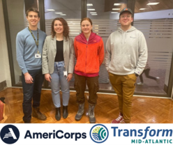 Four people standing together with a banner at the bottom of the picture