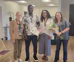 : Tonny with IRC staff at the IRC office on the day after his citizenship ceremony 