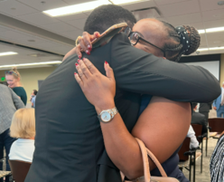 Tonny with his cousin after he completes the oath