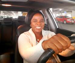 Flavia driving her car.