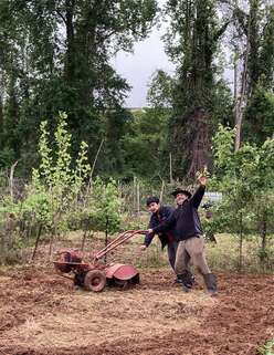 Two men work on the farm