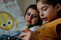 Adult and child reading together