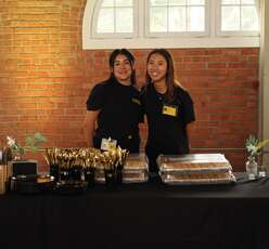 Interns Samantha (left) and Ellie (right) supporting the Taste of the IRC event in 2024.