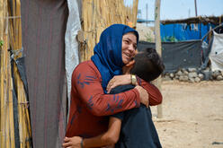 Yasser with his mother outside the family's tent in a camp for displaced people in northeast Syria.