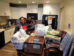 Refugee family receives gifts during the International Rescue Committee in Salt Lake City's annual holiday drive.