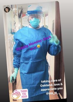 Torbertha Torbor at work. She is wearing a mask, a face shield, and a gown.