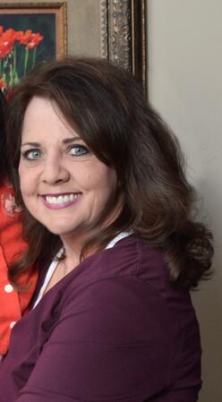 Joanne, IRC volunteer, holding her adopted daughter.