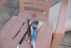 Diala Brisly's paintbrushes sit on a chair on her terrace