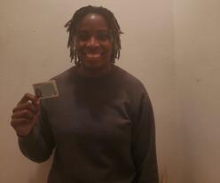 A picture of a client in NJ, smiling and holding her new Commercial Driver License.