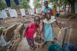 Girls fetch water at an IRC-installed pump
