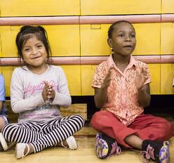 Students cheer classmates during a basketball game at the 2016 Refugee Youth Summer Academy.