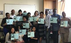 Hospitality Link participants graduate program and show their diplomas.