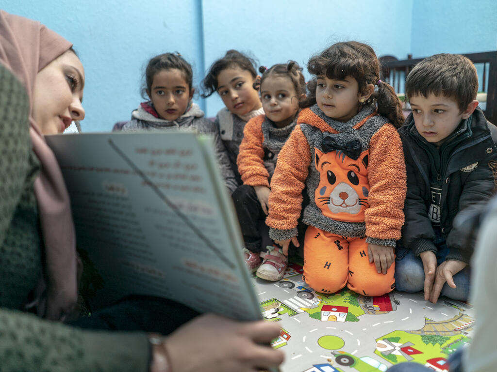 Children participate in Ahlan Simsim learning activities. 