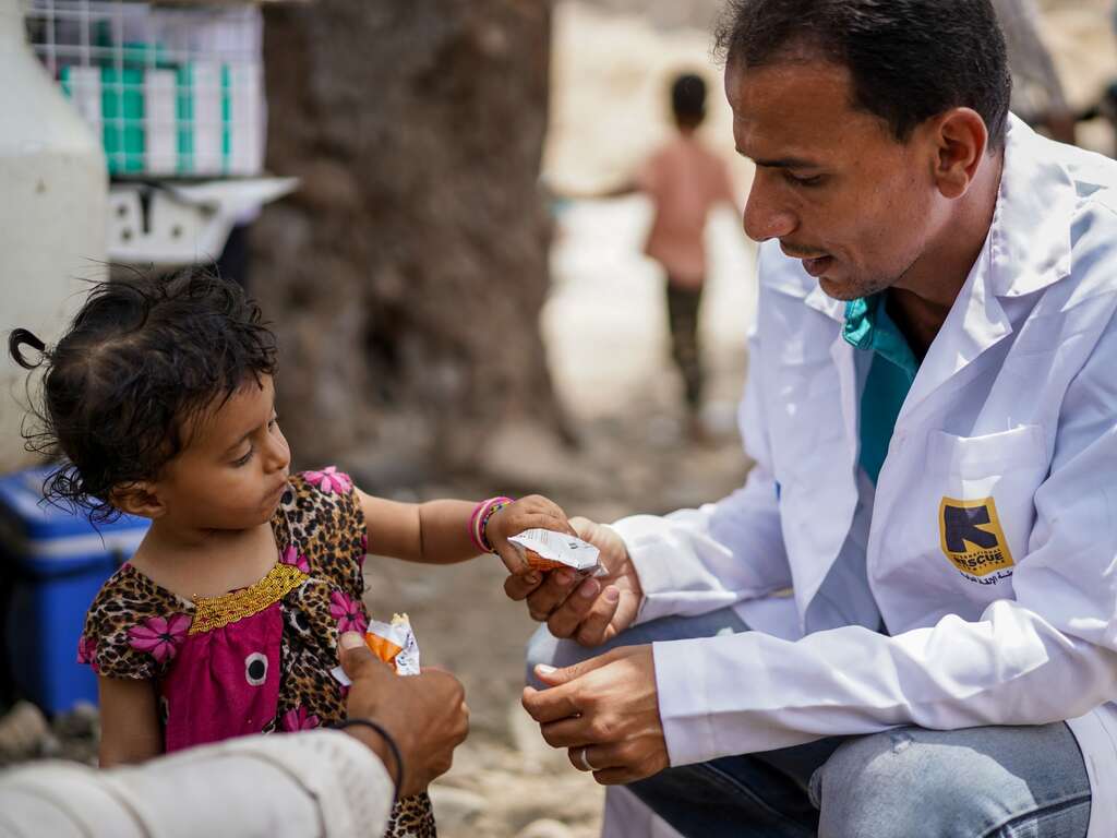 A child receives treatment for malnutrition from an IRC health care worker in Yemen.