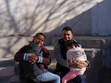 Natalia and José hold their two children.