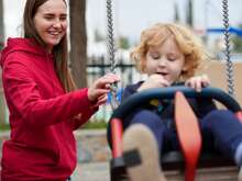 A mother smiling behind her child