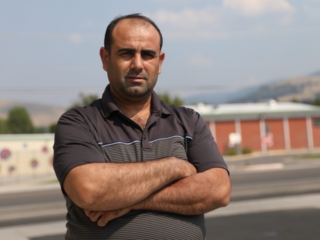 An IRC client poses for a photo outside the office