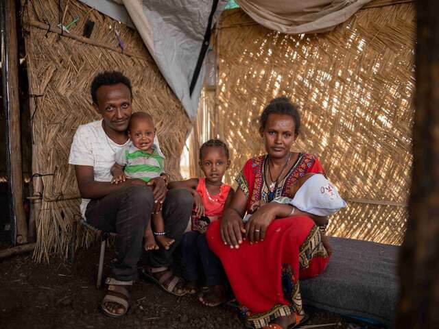 Almas, 33, sits with her family in their tent at Gedaref camp. Her young son, once severely malnourished, received treatment there.