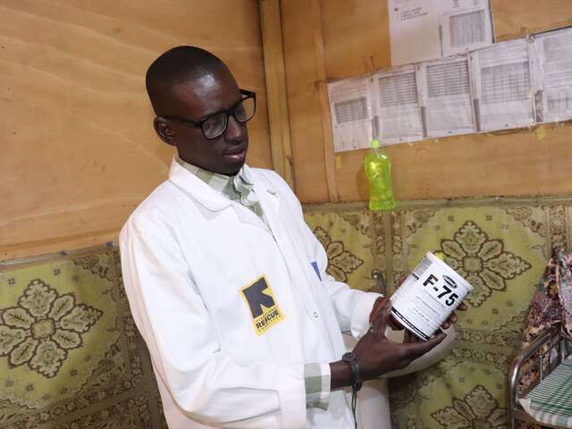 Dr Traoré prepares a dose of therapeutic milk for a child with severe acute malnutrition. This early stage formula, known as F-75, is crucial for stabilising young children before they move on to more intensive feeding.