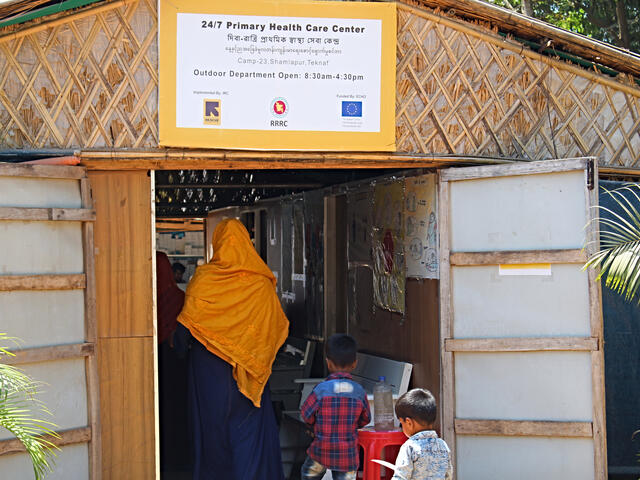 Sakera Akter and her two young sons enter the IRC's primary health care center in Cox's Bazar