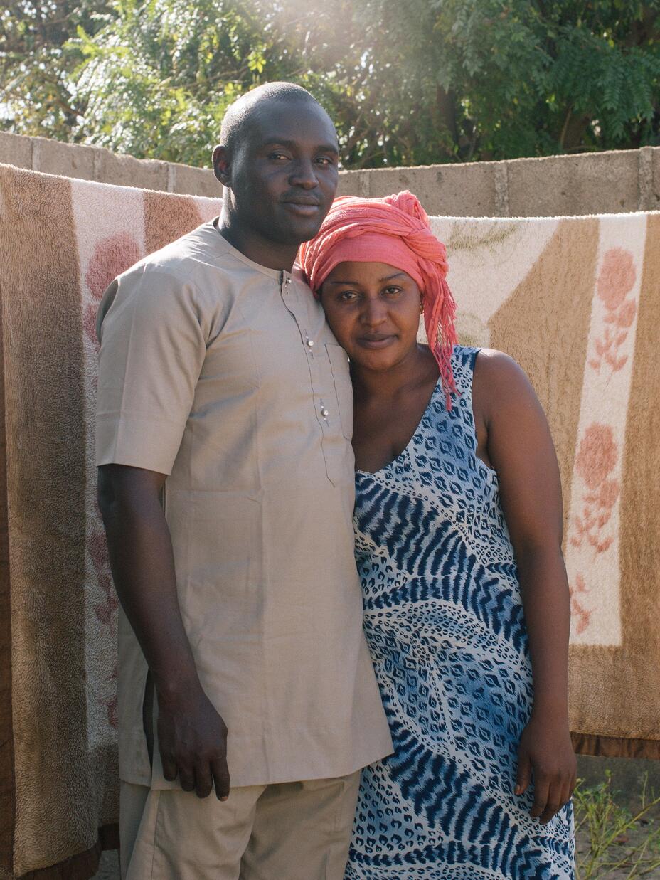 The couple hugging in their backyard
