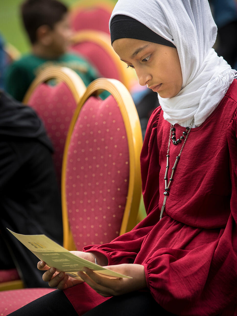 Sidra looks at her father Khalil’s graduation certificate.