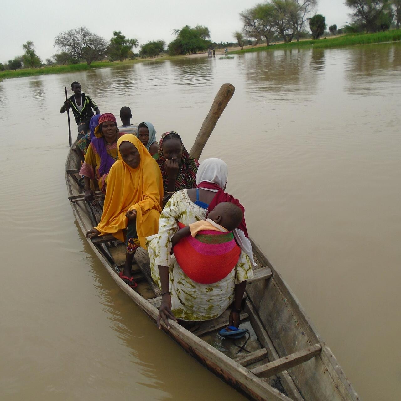 Some People in small boat in muddy water