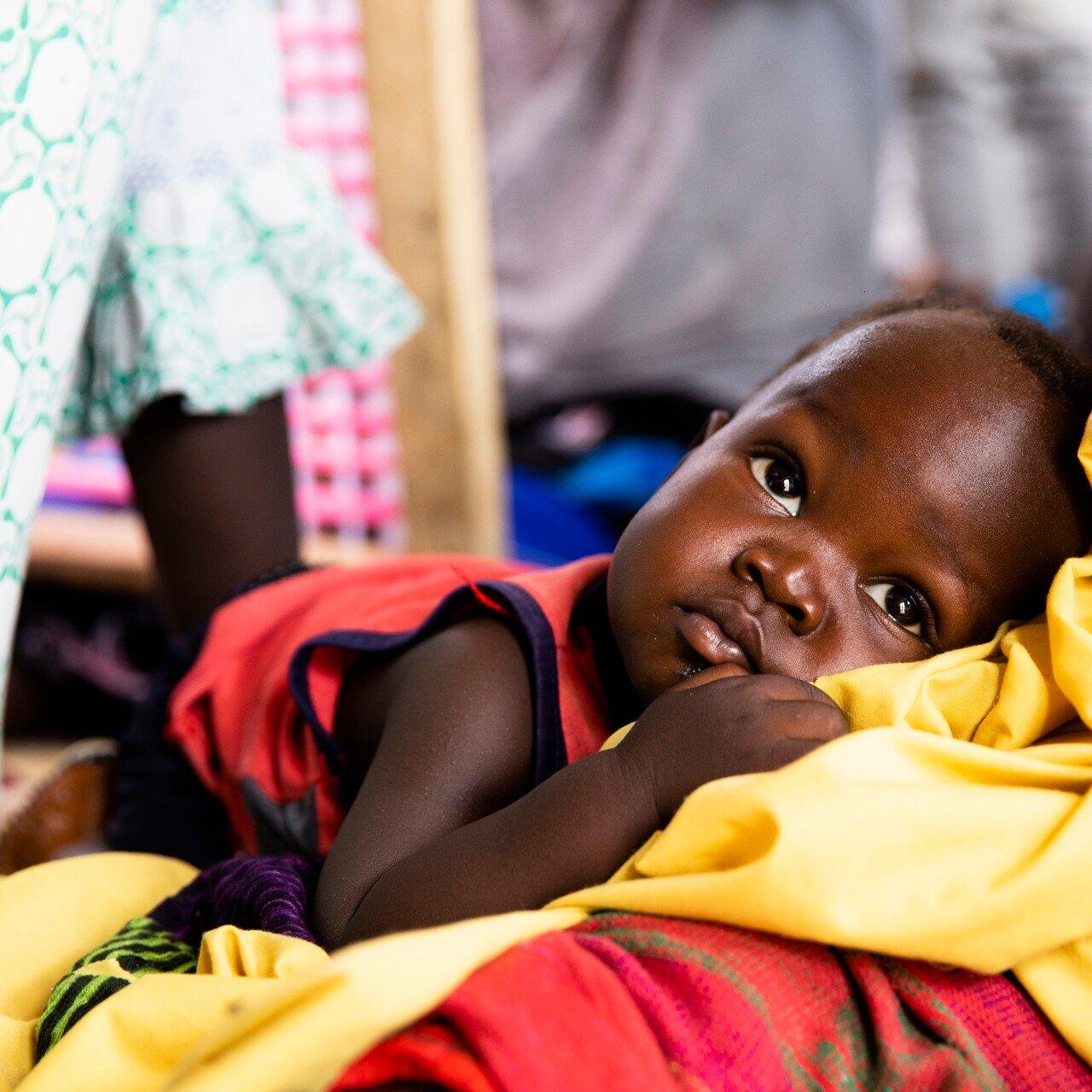 A baby boy laying on his mother