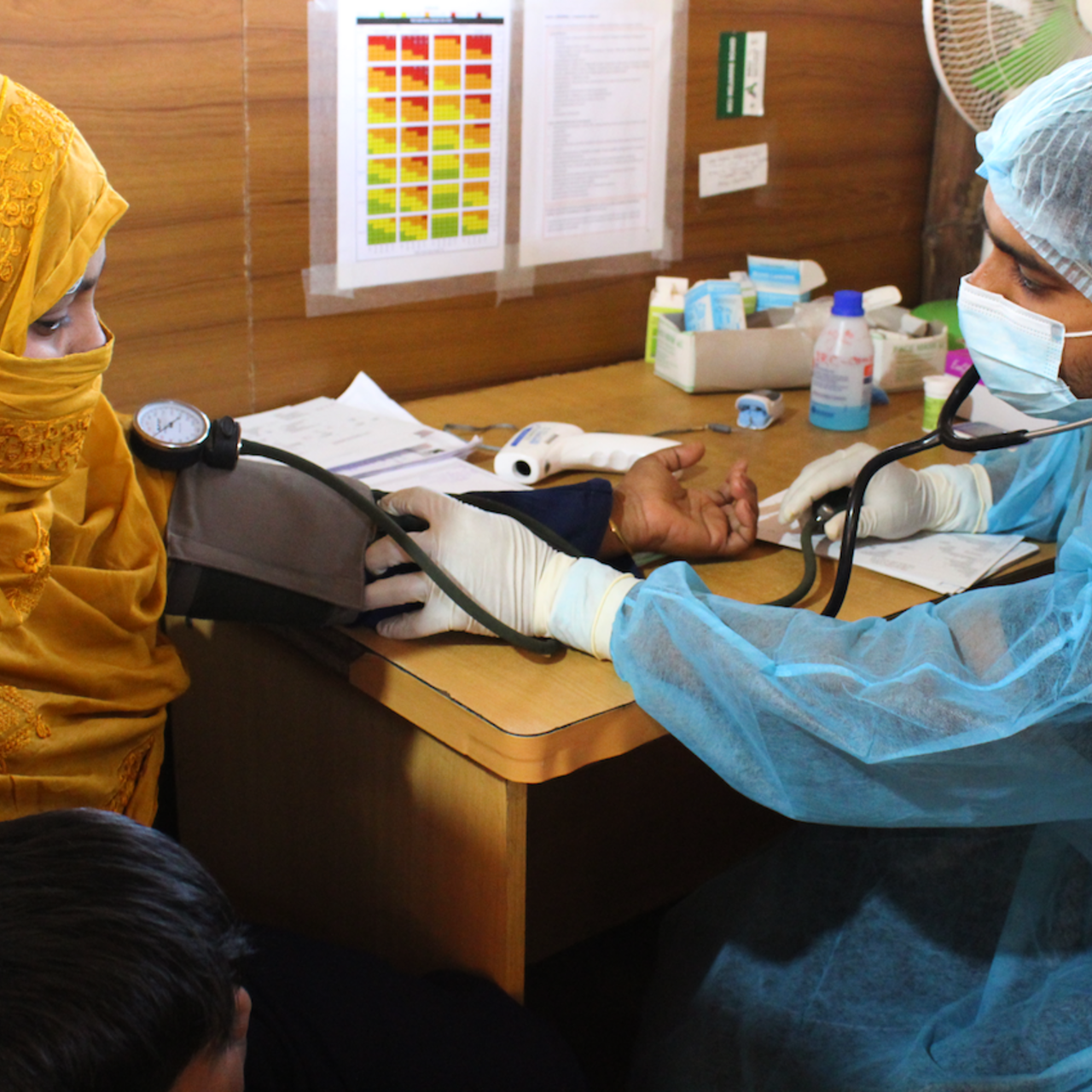 A woman getting her temperature measured in the IRC clinic in Bangladesh.