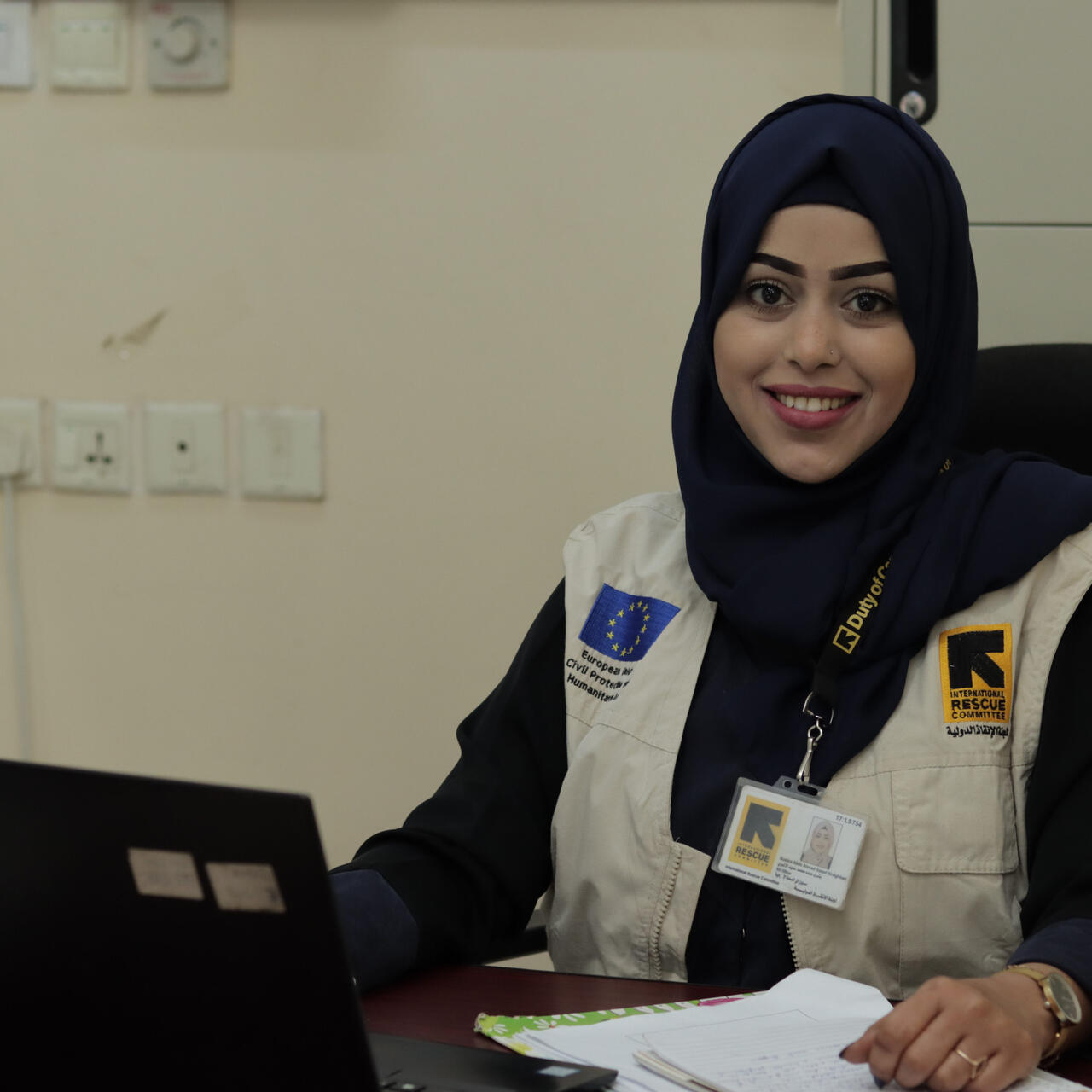 Bushra sitting at her work desk