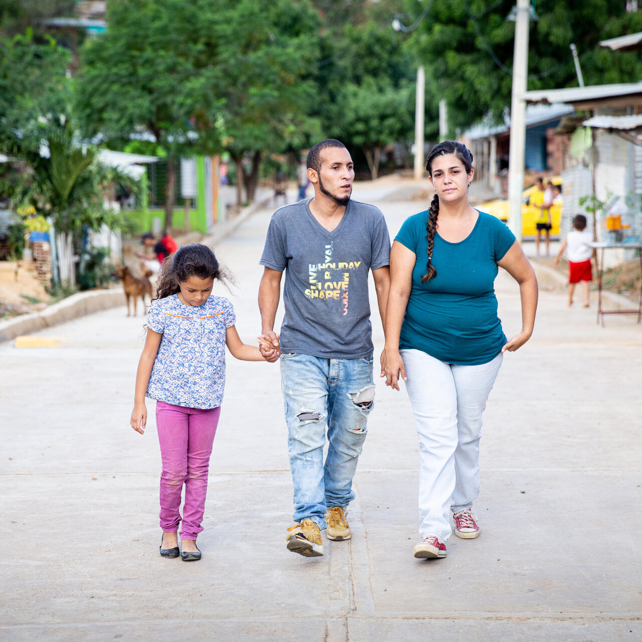 Andrea and her family, who left Venezuela, walk near their new home in Cucuta, Colombia.