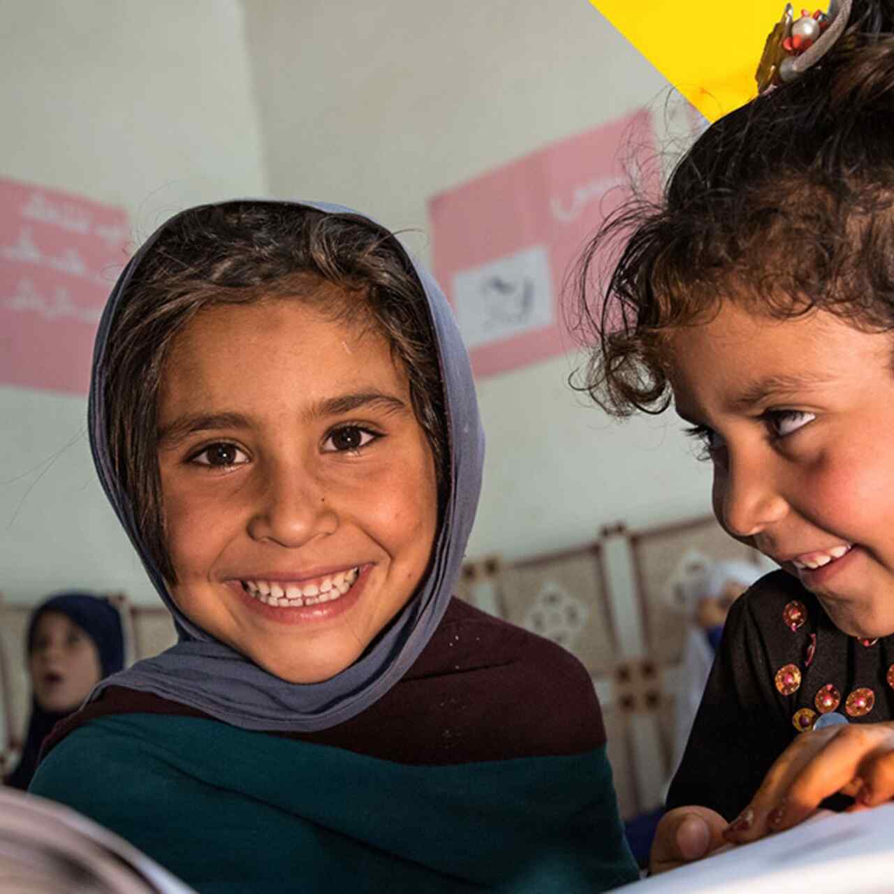 Two young students in a classroom