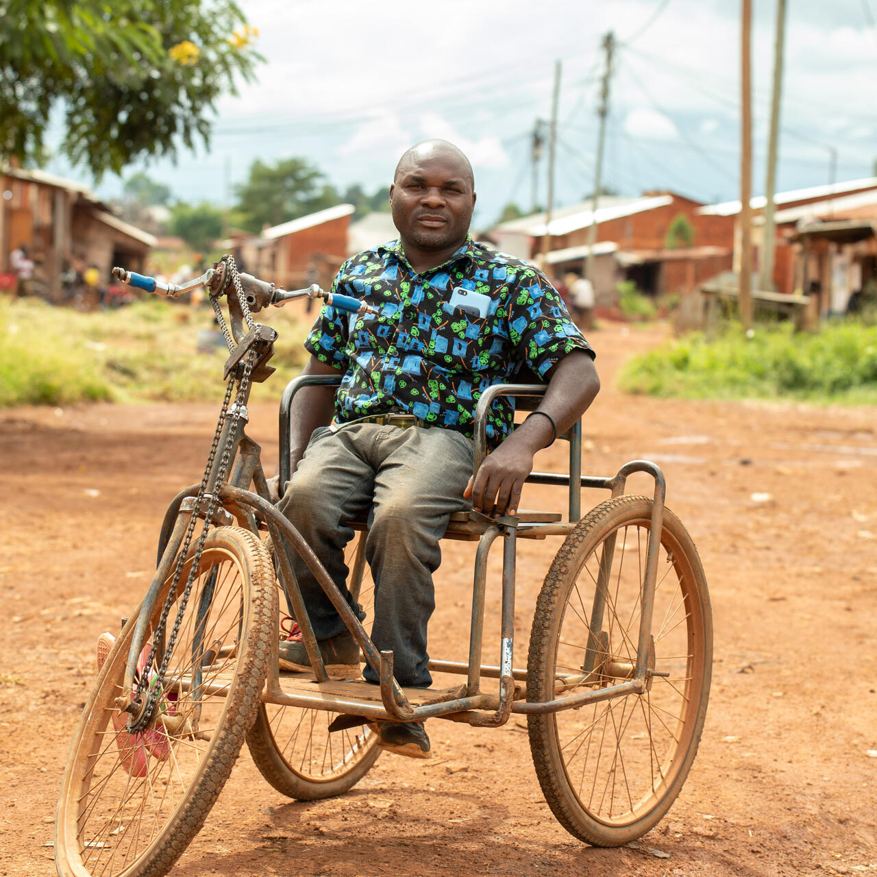 A man sits on a motorcycle in Tanzania.