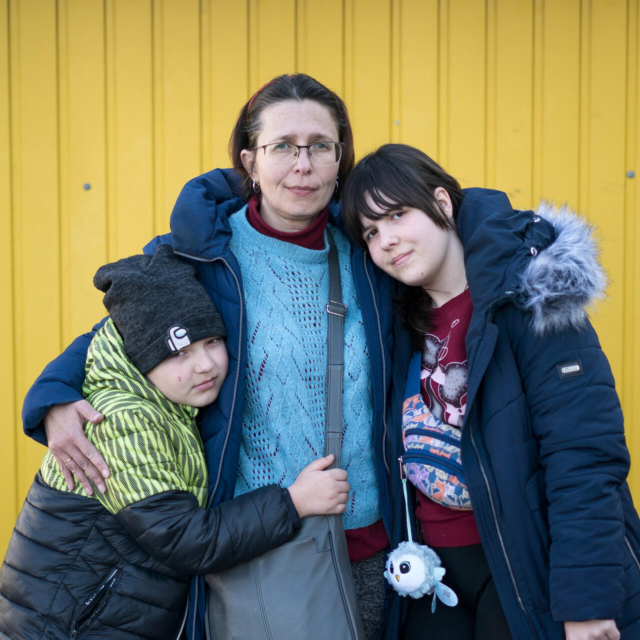 A mother and her two children pose for a photo in Poland after fleeing the war in Ukraine.