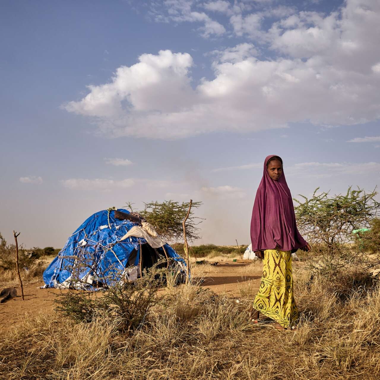 A young girl walks away from a temporary shelter in Mali.