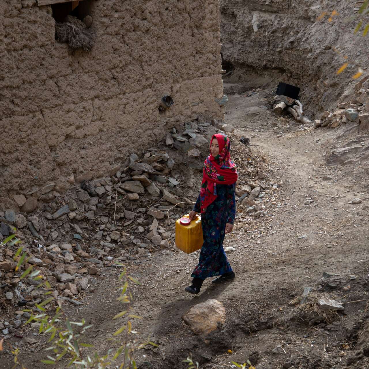 Rozama, 27, walks towards the river to collect water in Sabzaab Bala village, Bamiyan province, Afghanistan.