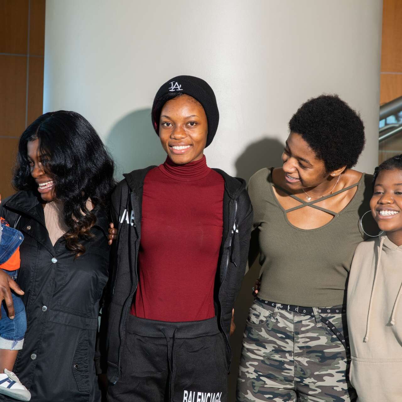 A family is reunited, sharing smiles and hugs.