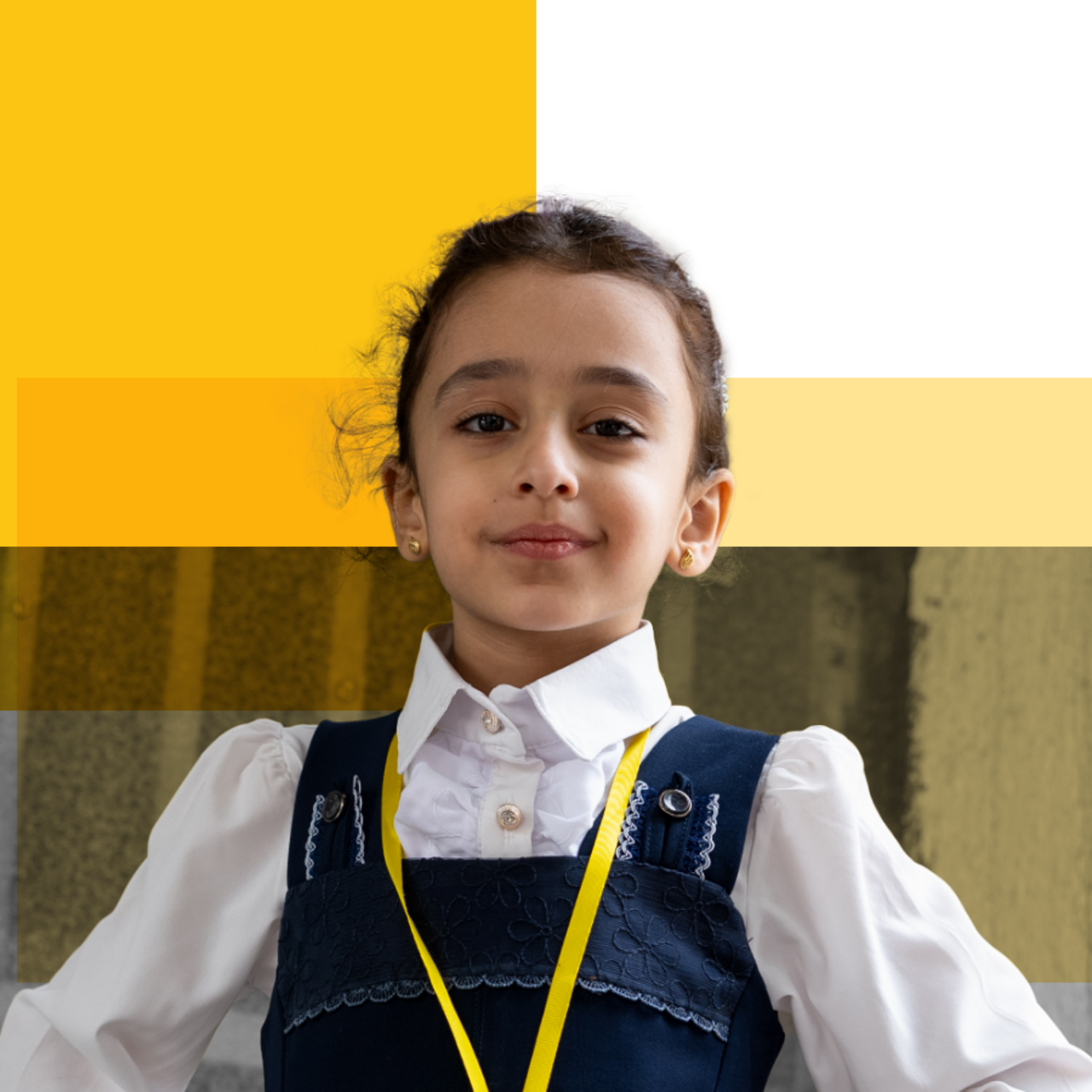 한 어린이가 자신감 넘치는 포즈로 웃고 있습니다.