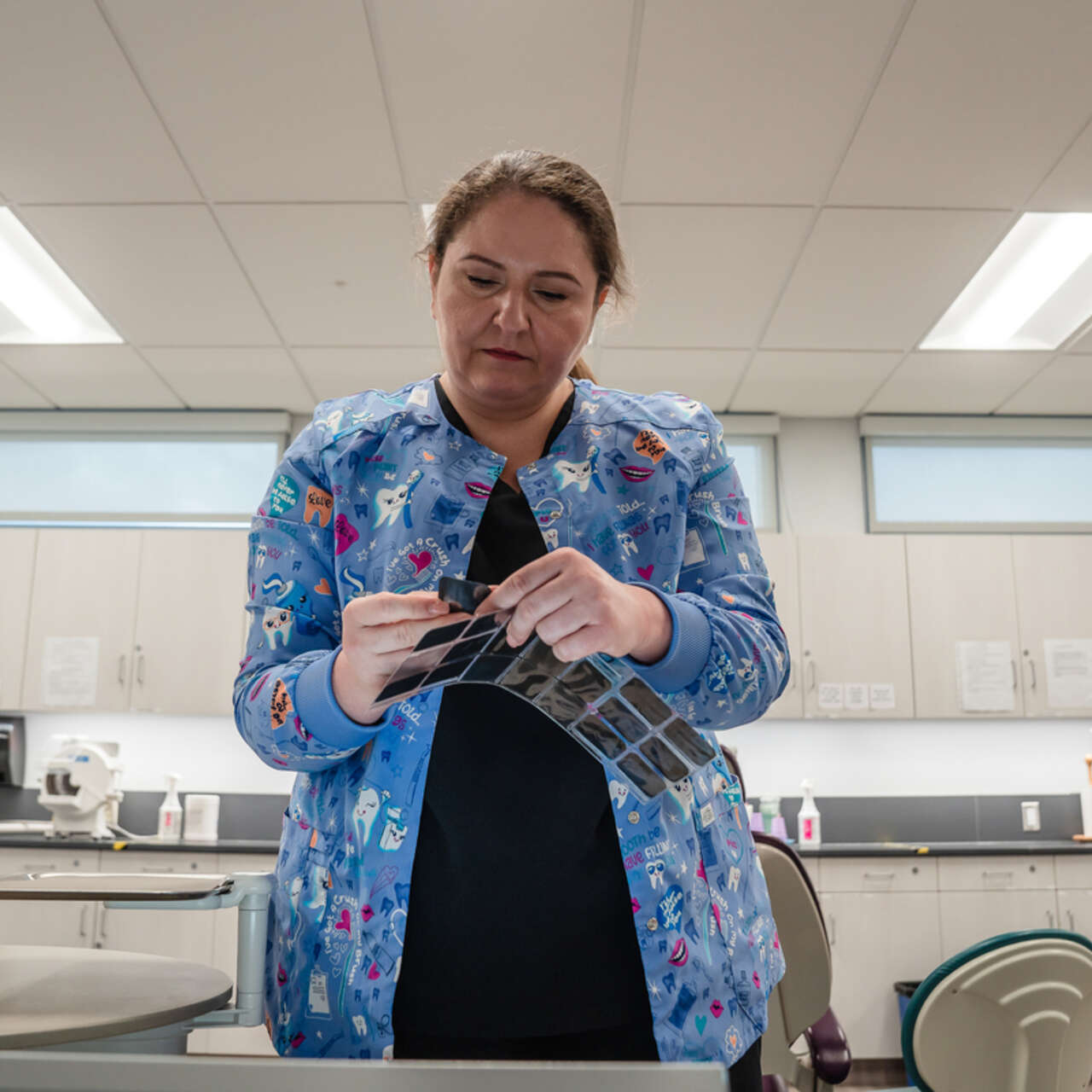 Yuliia in the dentist's room, checking x-rays.