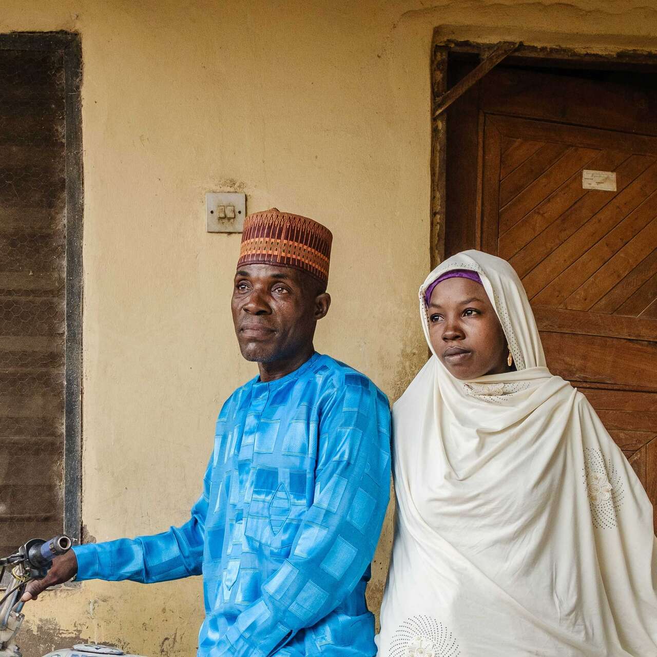 나이지리아 국제구조위원회 고객이 집 앞에서 사진을 찍고 있습니다.