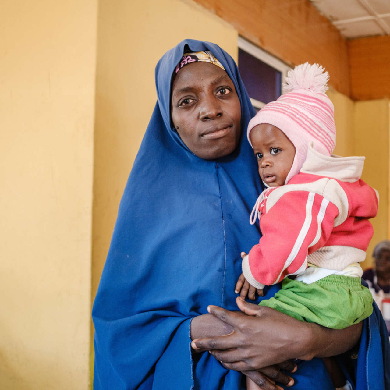 Hafsat Ibrahim holds her 10-month baby Ahmad at Sulumburi Health Clinic, Nigeria.