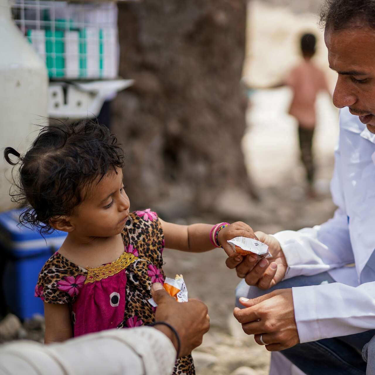 A child receives treatment for malnutrition from an IRC health care worker in Yemen.