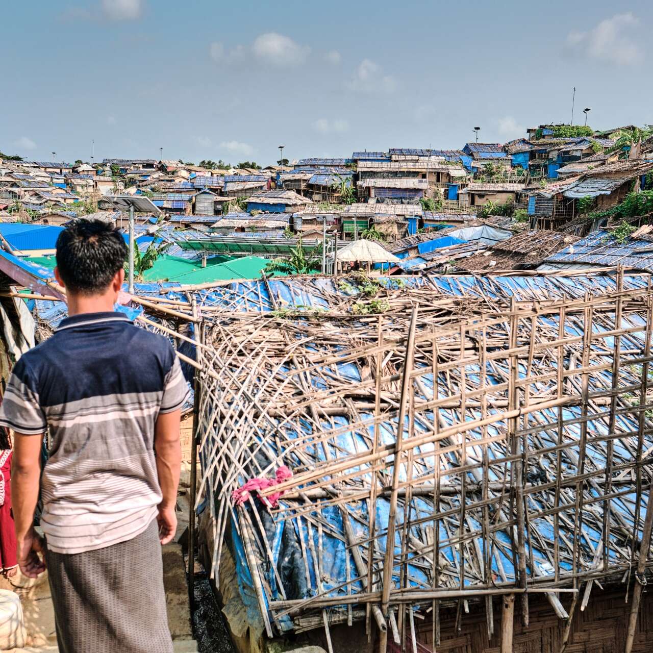 A Rohingyan man looks out over Cox's Bazar refugee camp in Bangladesh.