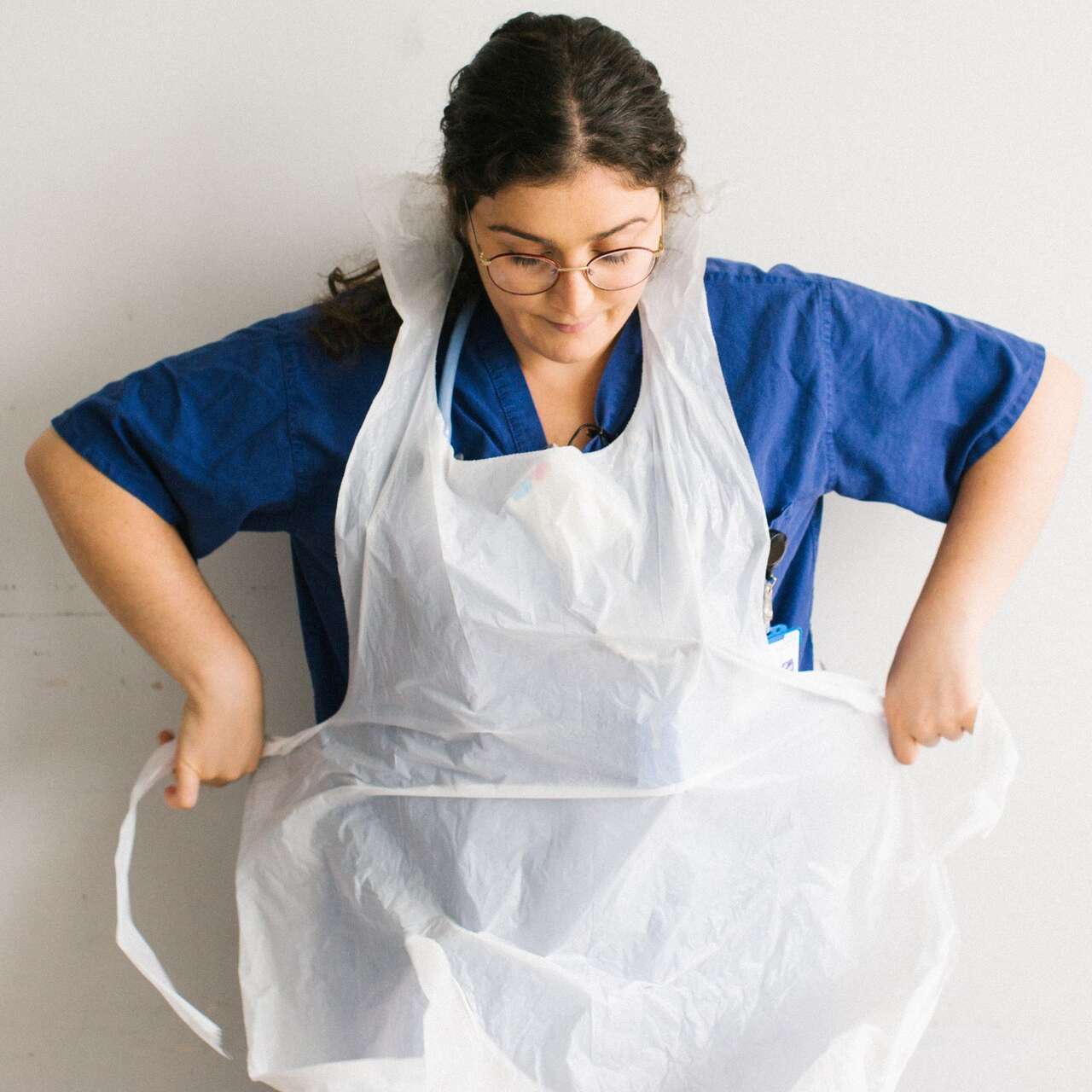 Anxhela Gradeci ties her apron