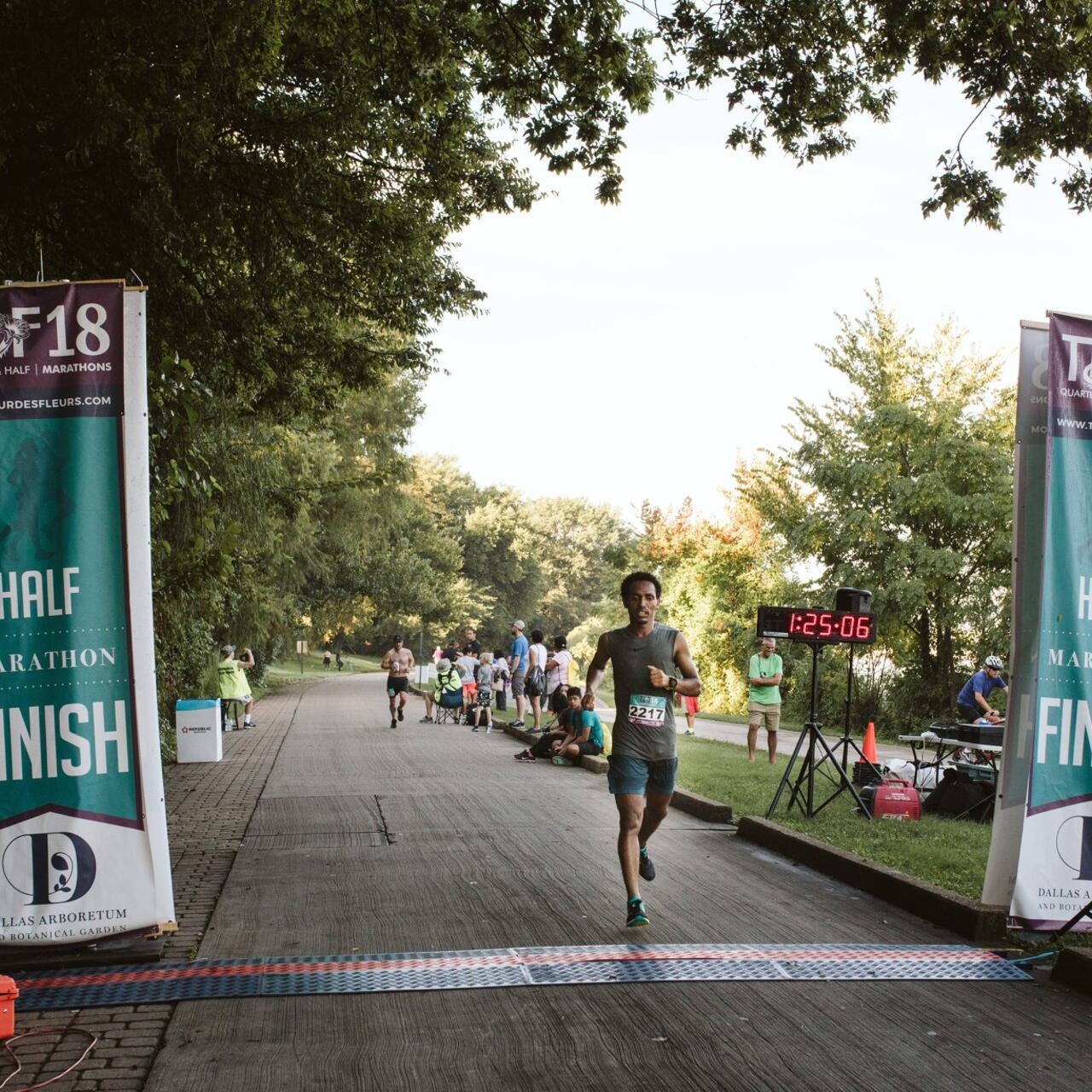 Tolassa Elemaa crosses the finish line of a race in Dallas