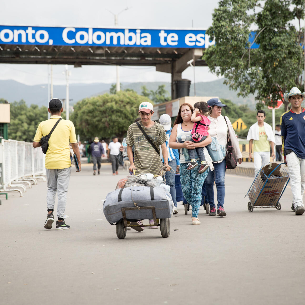 People carrying children and baggage walk across the Simon Bolivar bridge linking Venezuela and Colombia.