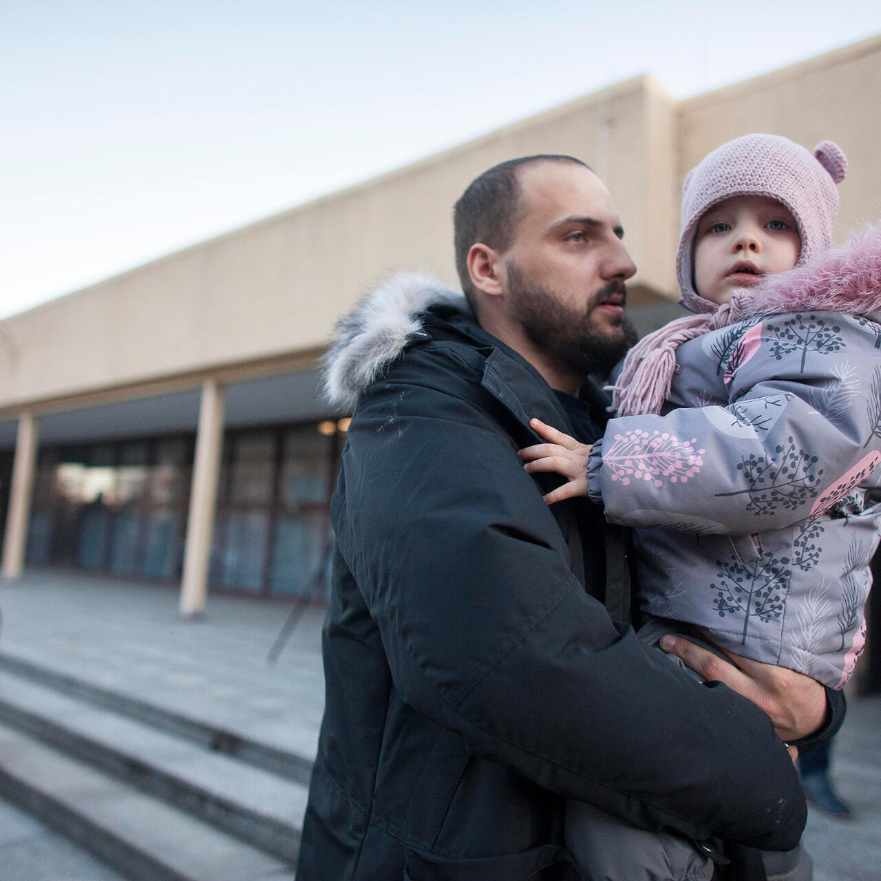 A man holds his child as par of the first train of refugees arriving in Poland.