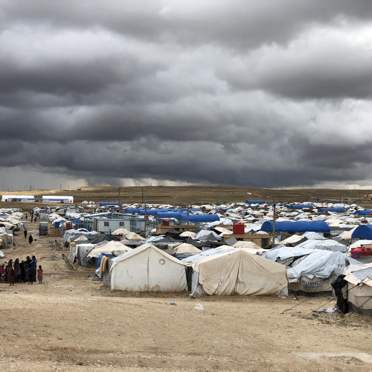 Dark clouds gather over the tents of Al Hol camp in northeastern Syria, now home to families displaced by 10 years of conflict