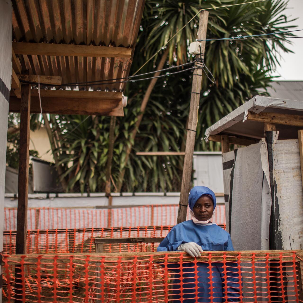 Ebola survivor Kahindo Kamala, wearing PPE, stands outside the Ebola treatment unit at hospital where she works in eastern Democratic Republic of Congo