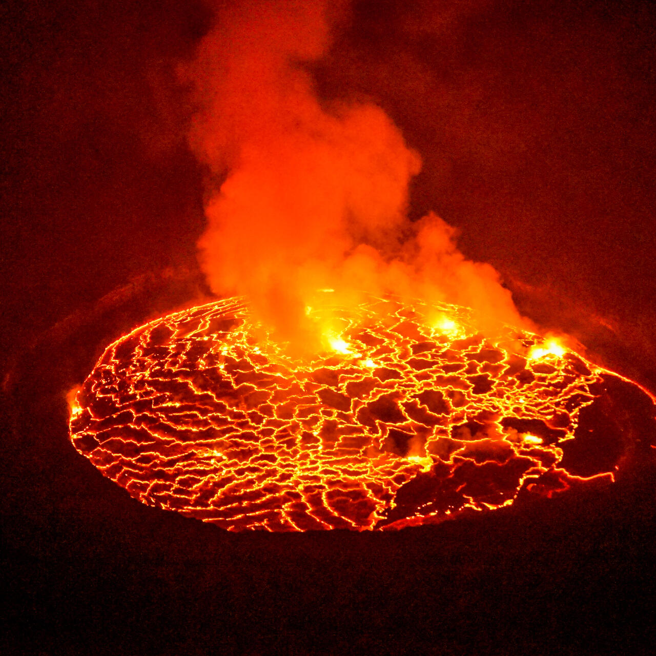Aerial view of steaming lava lake in the glowing crater of Mt. Nyiragongo near Goma